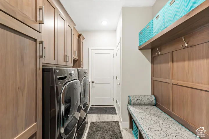 Custom wood-finish cabinetry, built-in wall hooks, integrated wood-finish bench, wood-finish flooring, and recessed lighting