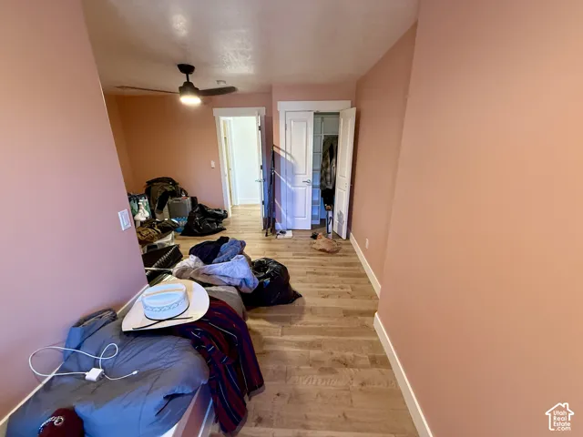 Bedroom 3 Wood-finish flooring, ceiling fan with integrated lighting, and closet with double-panel doors