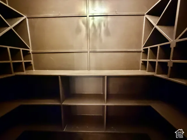 Custom dark-toned cabinetry featuring built-in grid wine storage and multi-level shelving