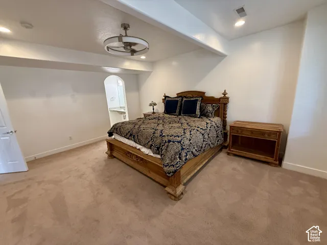 Bedroom 5 featuring neutral wall-to-wall carpeting, recessed ceiling lighting, and a modern circular chandelier with integrated fan and  Jack & Jill bathroom