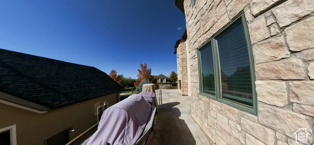 Exterior elevation featuring natural stone masonry, multi-pane windows with dark frames