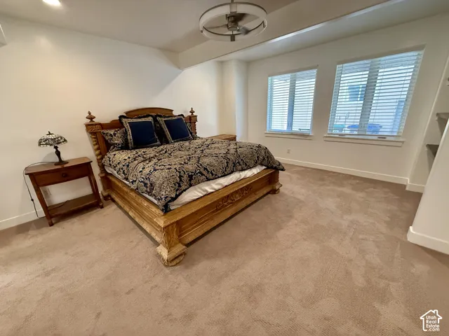 Bedroom 5 carpeted flooring, two double-paned windows, and a modern circular ceiling fan with integrated lighting and Jack & Jill bathroom