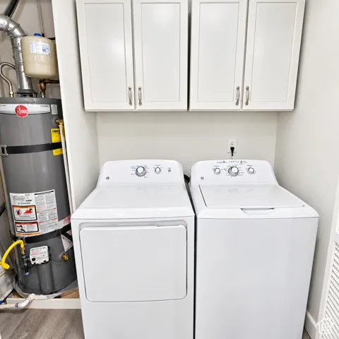 Washer and Dryer included along with white shaker-style wall-mounted cabinetry with satin nickel hardware.
