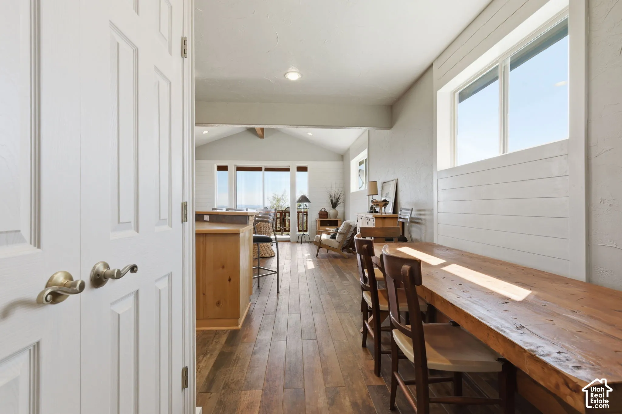 Wood-finish flooring, white shiplap wall accents, built-in wooden counter surface, and recessed ceiling lighting