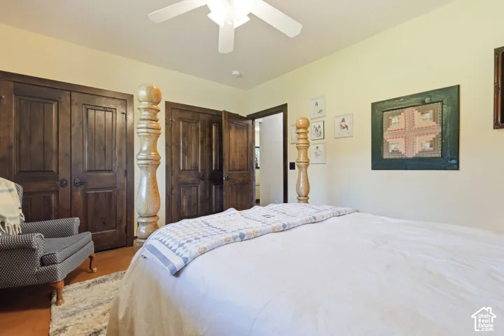 Room featuring dual stained-wood doors, ceiling-mounted fan, and polished concrete flooring
