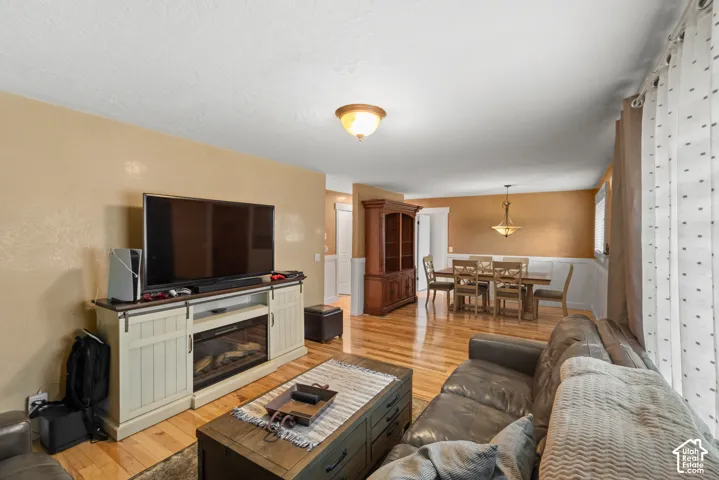 Wood-finish flooring, half-wall wainscoting, and recessed ceiling lighting