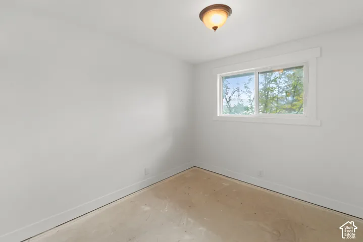 Interior room featuring a sliding window with clean-lined molding and a flush-mount overhead light fixture