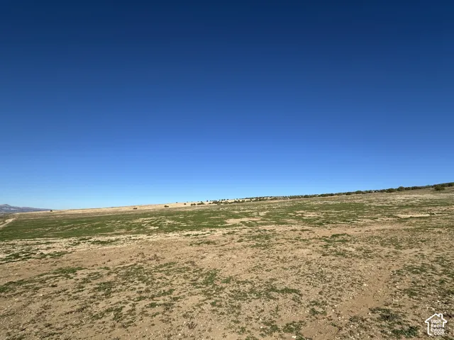 Expansive acreage featuring natural terrain and distant mountain topography