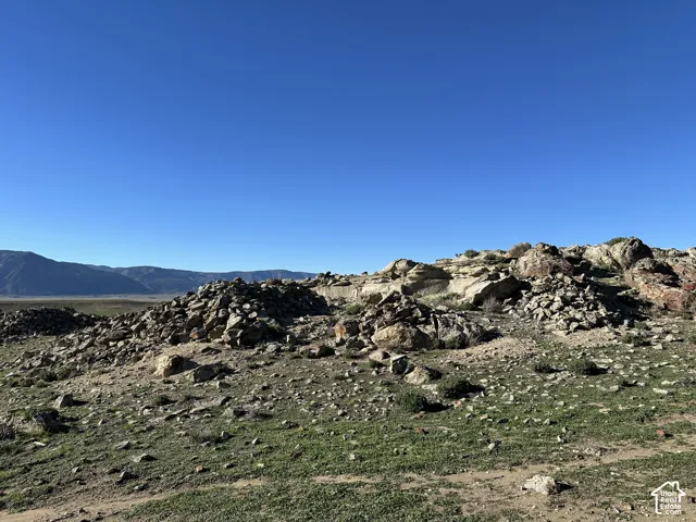Expansive natural landscape featuring rock formations and mountain terrain