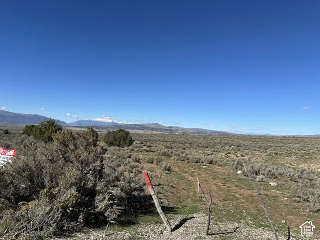 Expansive acreage featuring native vegetation and prominent mountain range backdrop