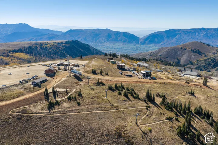High-altitude mountain terrain featuring rugged ridgelines, alpine vegetation, and established access trails
