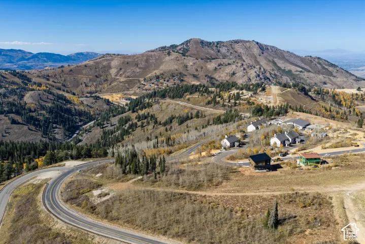 Aerial perspective showcasing mountainous topography, rugged terrain, and surrounding native vegetation