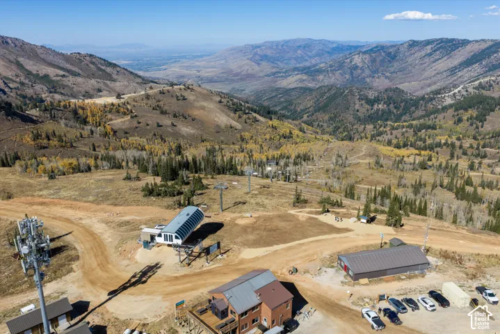 Aerial perspective of mountainous terrain featuring elevated ridgeline topography, expansive alpine landscapes, and direct proximity to chairlift infrastructure