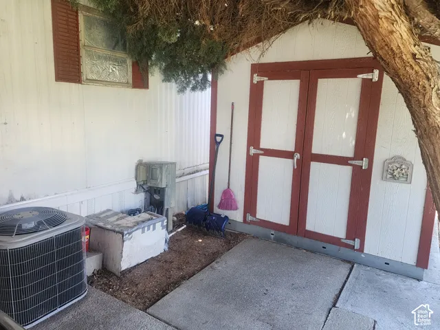 Exterior storage shed featuring double-door entry and concrete pad