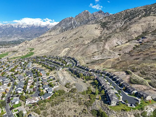 Aerial perspective of a residential community situated against a prominent mountain backdrop