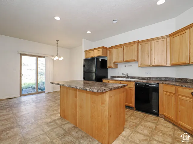 Kitchen featuring natural wood cabinetry, central island, laminate countertops, recessed lighting, and tile flooring