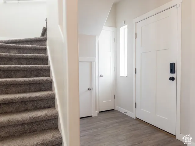 Entry way with coat closet, and under stair storage