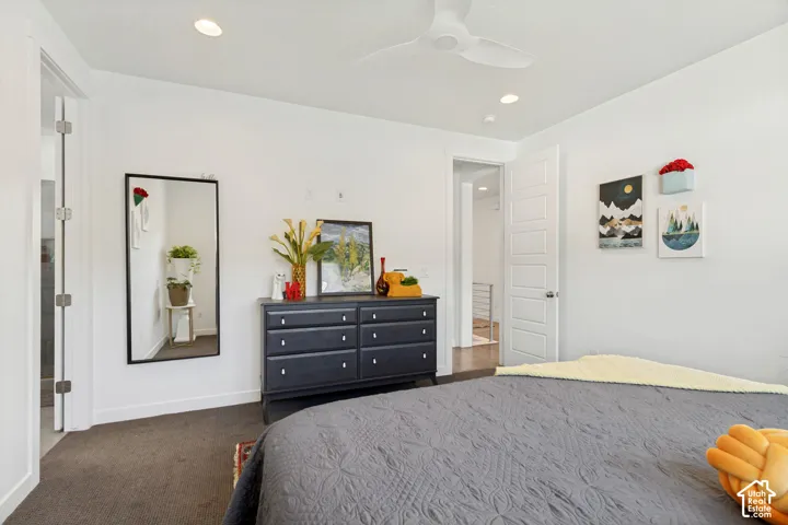 Room featuring neutral carpeting, recessed lighting, a modern ceiling fan, and five-panel interior doors