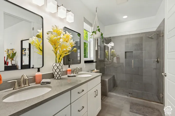 Double vanity with a quartz countertop, under-mount sinks, and two framed wall mirrors
