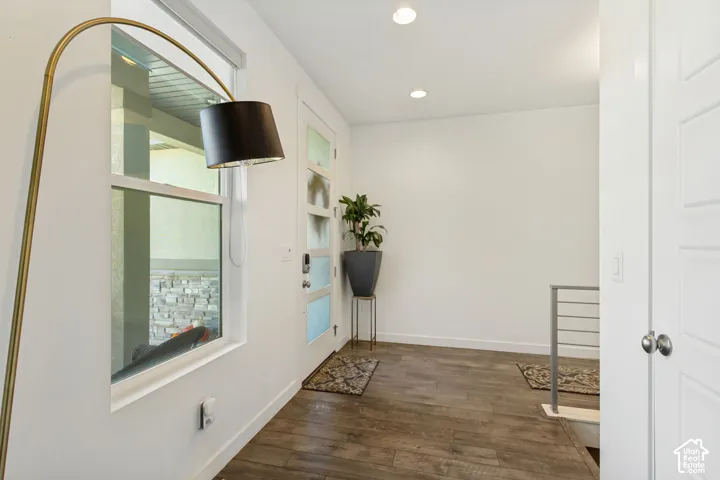 Entryway featuring wood-finish flooring, recessed lighting, and a multi-panel door with frosted glass inserts