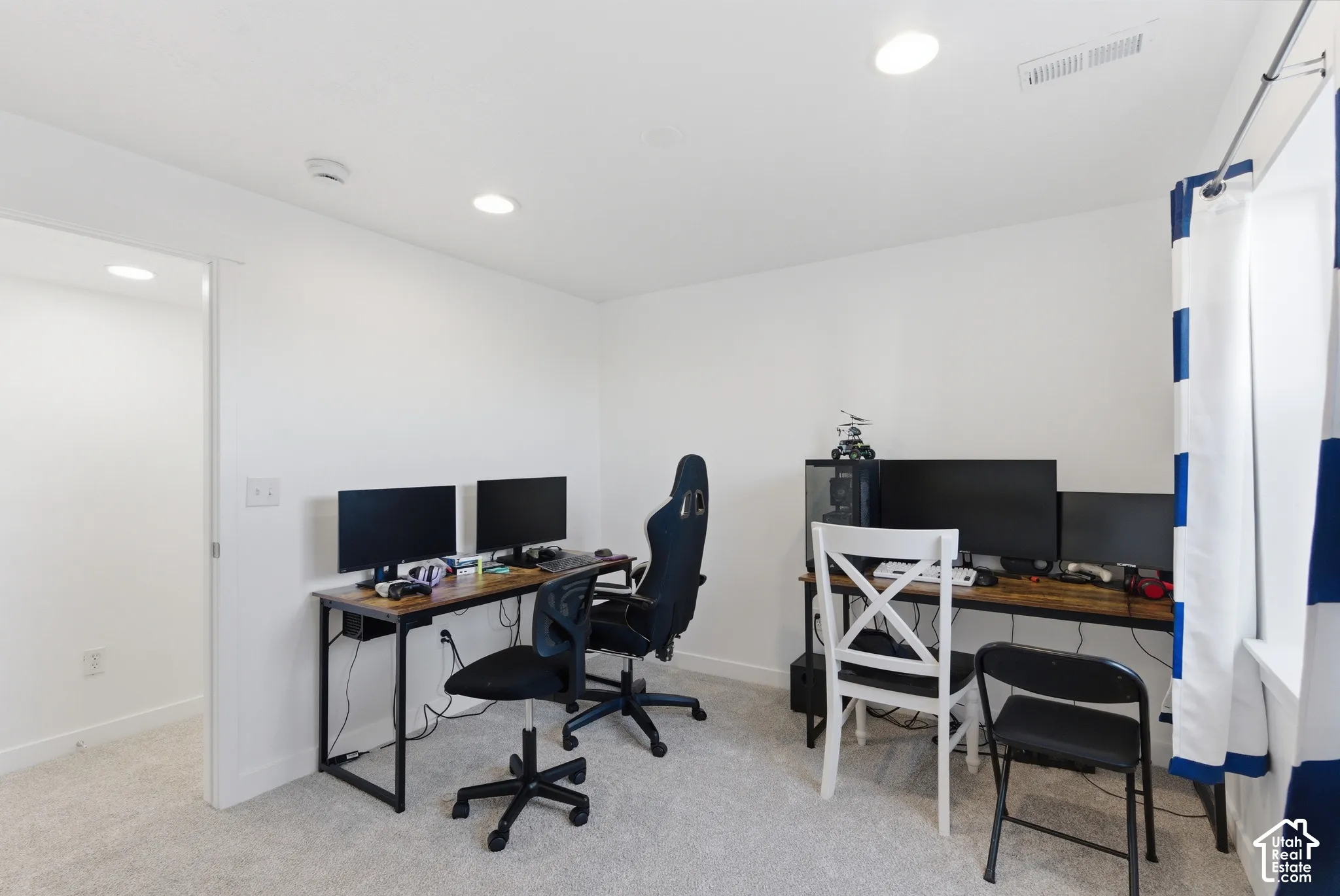 Neutral wall finishes, plush carpeting, and recessed lighting