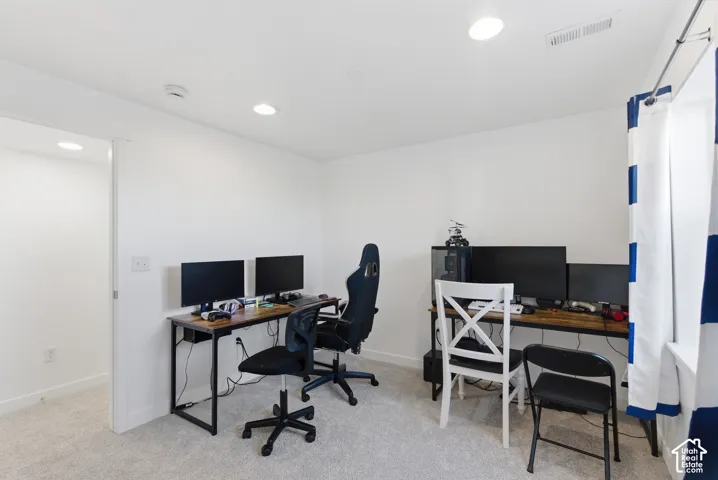 Neutral wall finishes, plush carpeting, and recessed lighting