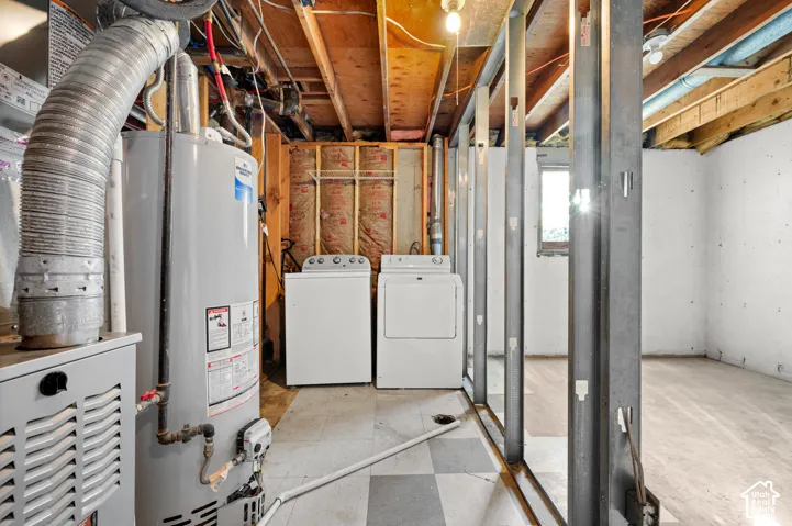 Unfinished utility area featuring exposed joist ceiling, metal wall stud framing, concrete walls, and vinyl tile flooring