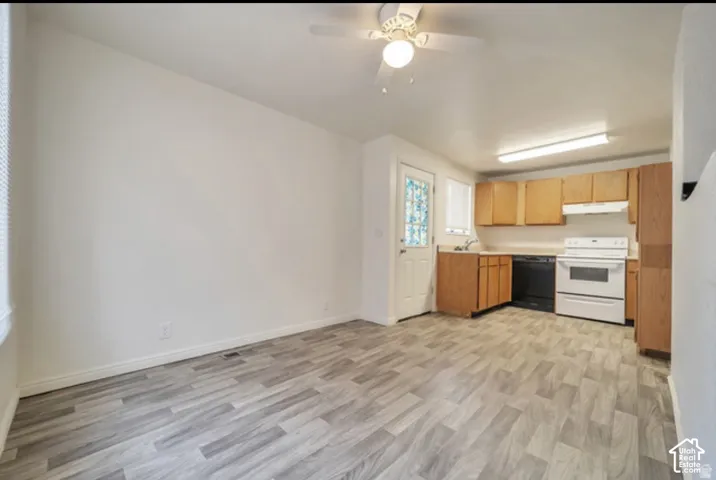 Kitchen featuring wood-finish cabinetry, wood-patterned flooring, a white range, a dark-toned dishwasher, and a ceiling-mounted fan