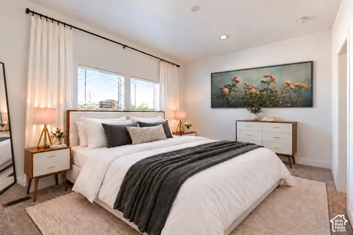Neutral interior featuring recessed lighting, plush wall-to-wall carpeting, and dual windows with black metal curtain rods