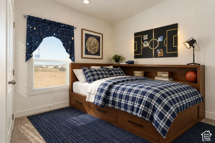 Neutral wall paint, recessed lighting, and a single-pane window with white trim