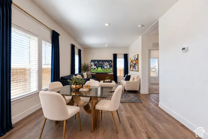 Open-concept interior featuring wood-finish flooring, recessed lighting, and expansive windows