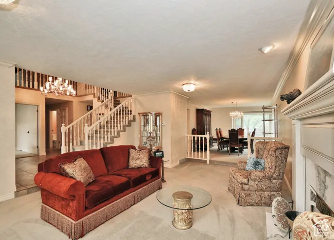 Open-concept interior featuring a wood-rail staircase, tiered floor levels, and a fireplace with a decorative mantel