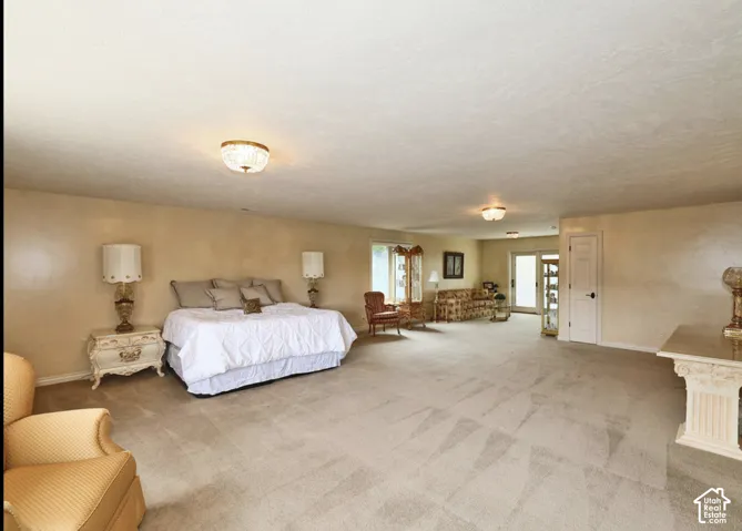 Spacious interior featuring carpeting, recessed and flush-mount lighting, and glass paneled doors