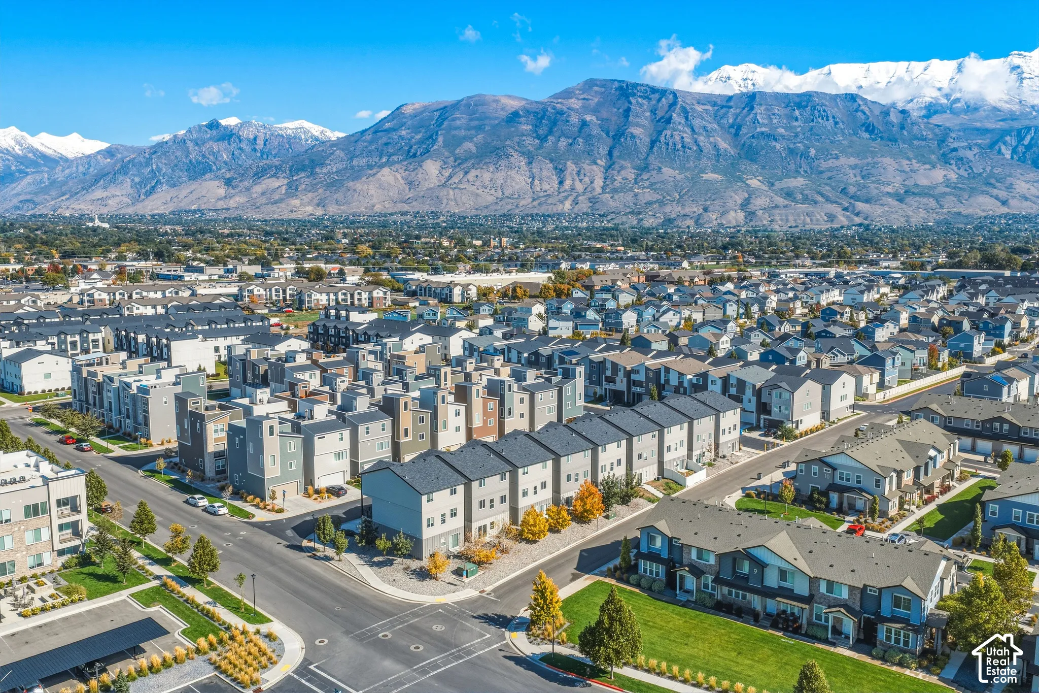 Aerial perspective featuring a multi-unit residential community set against a backdrop of snow-capped mountains