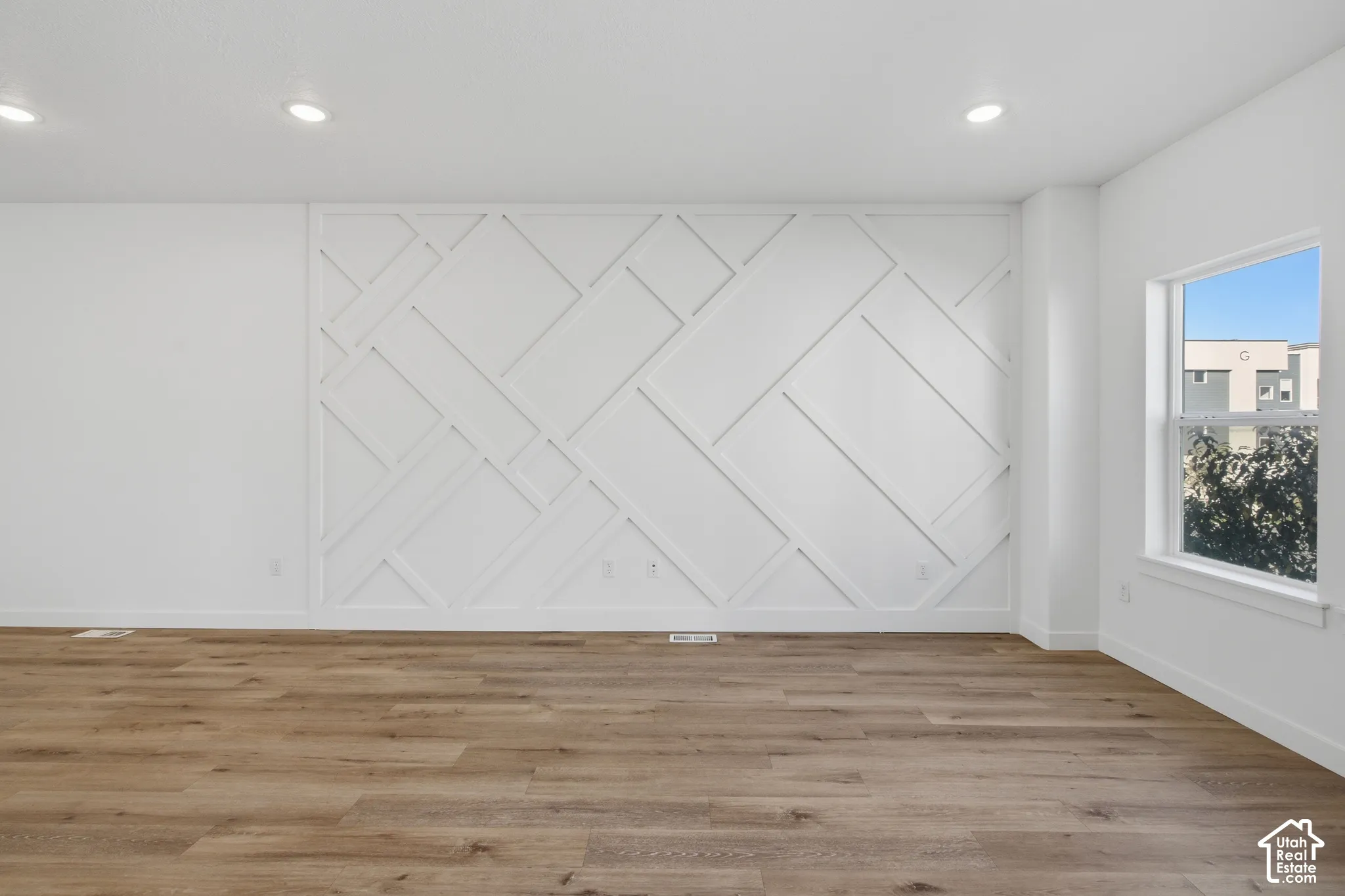 Geometric wood wall molding, wood-finish flooring, and recessed ceiling lighting
