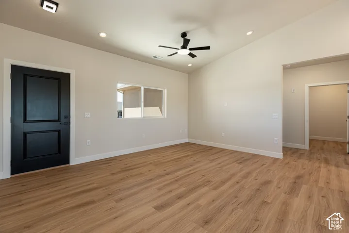 Wood-finish flooring, vaulted ceiling, recessed lighting, and a modern ceiling fan
