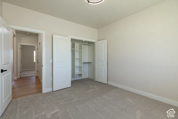 Light gray carpeting with white baseboards