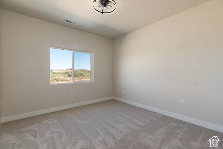 Wall-to-wall carpeting, neutral wall finishes, and a contemporary ceiling fan with integrated lighting