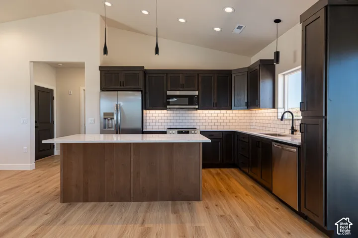 Vaulted ceiling with recessed lighting and pendant fixtures
