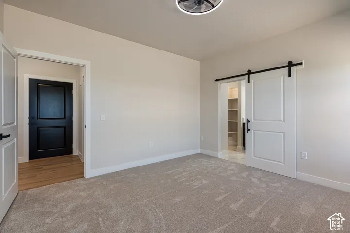 Light gray carpeting with white baseboards