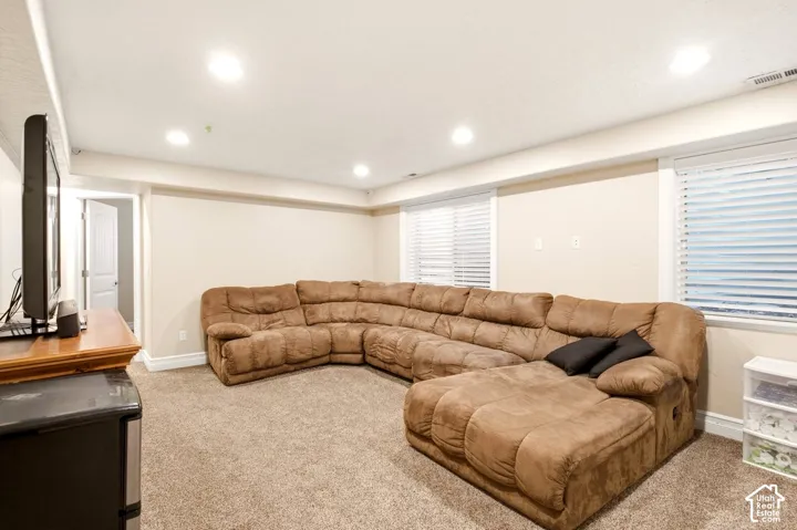 Interior space featuring recessed lighting, wall-to-wall carpeting, and dual windows with horizontal blinds