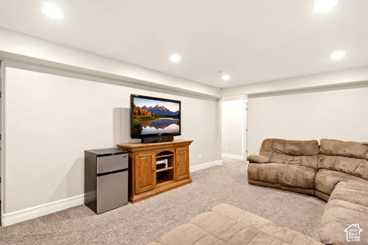 Neutral wall finishes, recessed ceiling lighting, and wall-to-wall carpeting