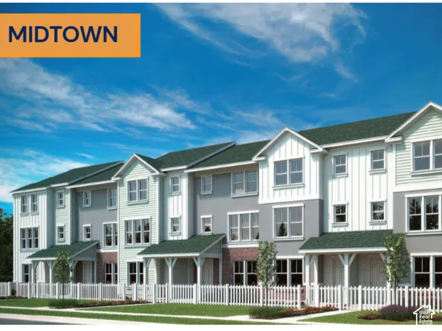 Multi-level residential exterior featuring board-and-batten siding, decorative brick masonry, gable rooflines, and individual covered entries enclosed by white picket fencing