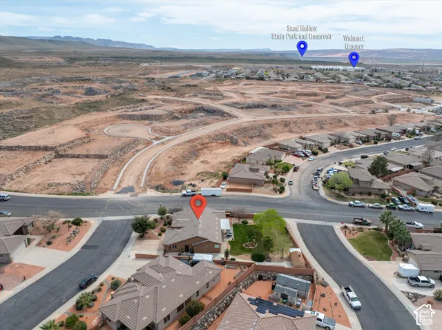 Aerial perspective featuring residential lots with paved street access and desert topography