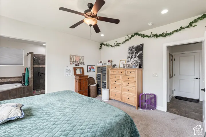 Neutral-toned bedroom featuring carpeted flooring, a ceiling fan with integrated lighting, recessed lighting, and solid-core interior doors