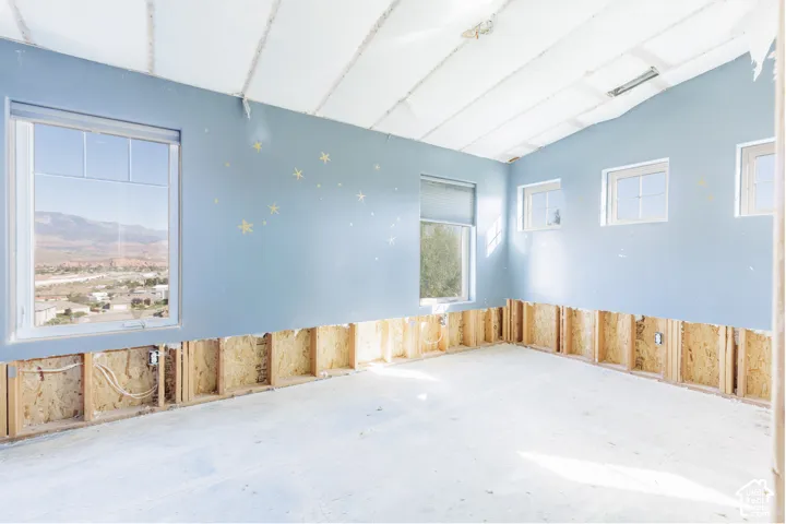 Interior space featuring multiple windows with mountain landscape scenery and exposed wood wall framing