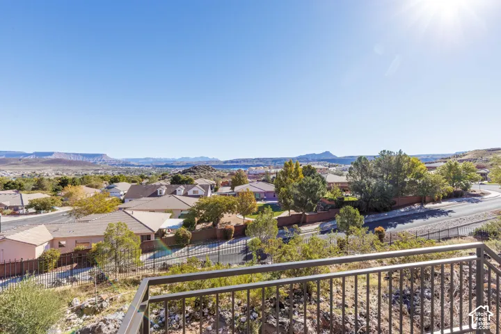 Elevated metal balcony railing overlooking panoramic mountain and desert landscape