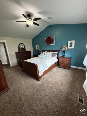 Vaulted ceiling featuring a ceiling fan with integrated lighting