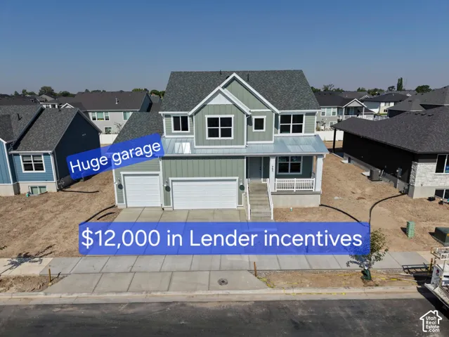 Two-story exterior featuring vertical siding, a front porch with white railing, and a three-car garage