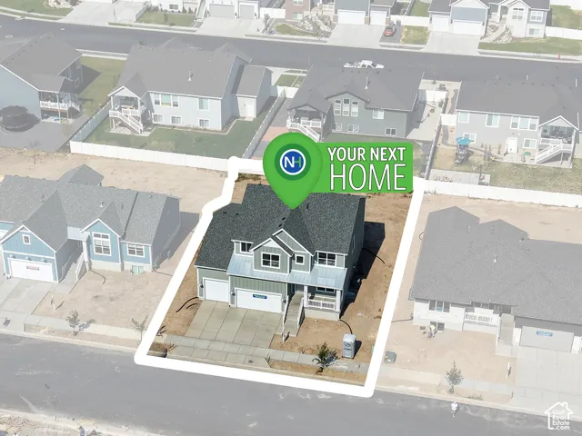 Two-story residential structure with a shingled roof, attached multi-car garage, concrete driveway, and covered front entryway